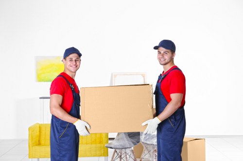 Professional movers handling furniture during house removals in Charlton