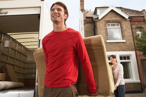 Local removals crew handling office equipment near loading access